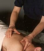 Photo of therapist massageing client's back